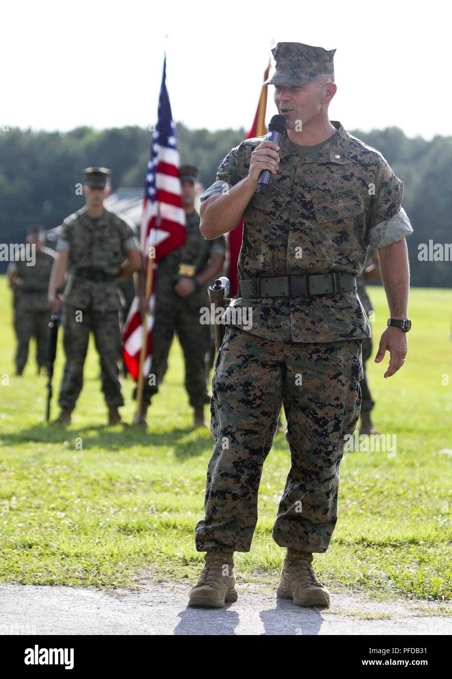 U.S. Marine Corps Lt. Col. Kyle G. Phillips, the off going commanding officer of Headquarters and Service (H&S) Battalion, School of Infantry-East, addresses Marines, sailors, family and friends during the H&S Battalion change of command ceremony at Camp Lejeune, N.C., June 8, 2018. The change of command ceremony represents the offical passing of authority from the off going commander, Lt. Col. Phillips to the on coming, Lt. Col. Amy E. Punzel. Stock Photo