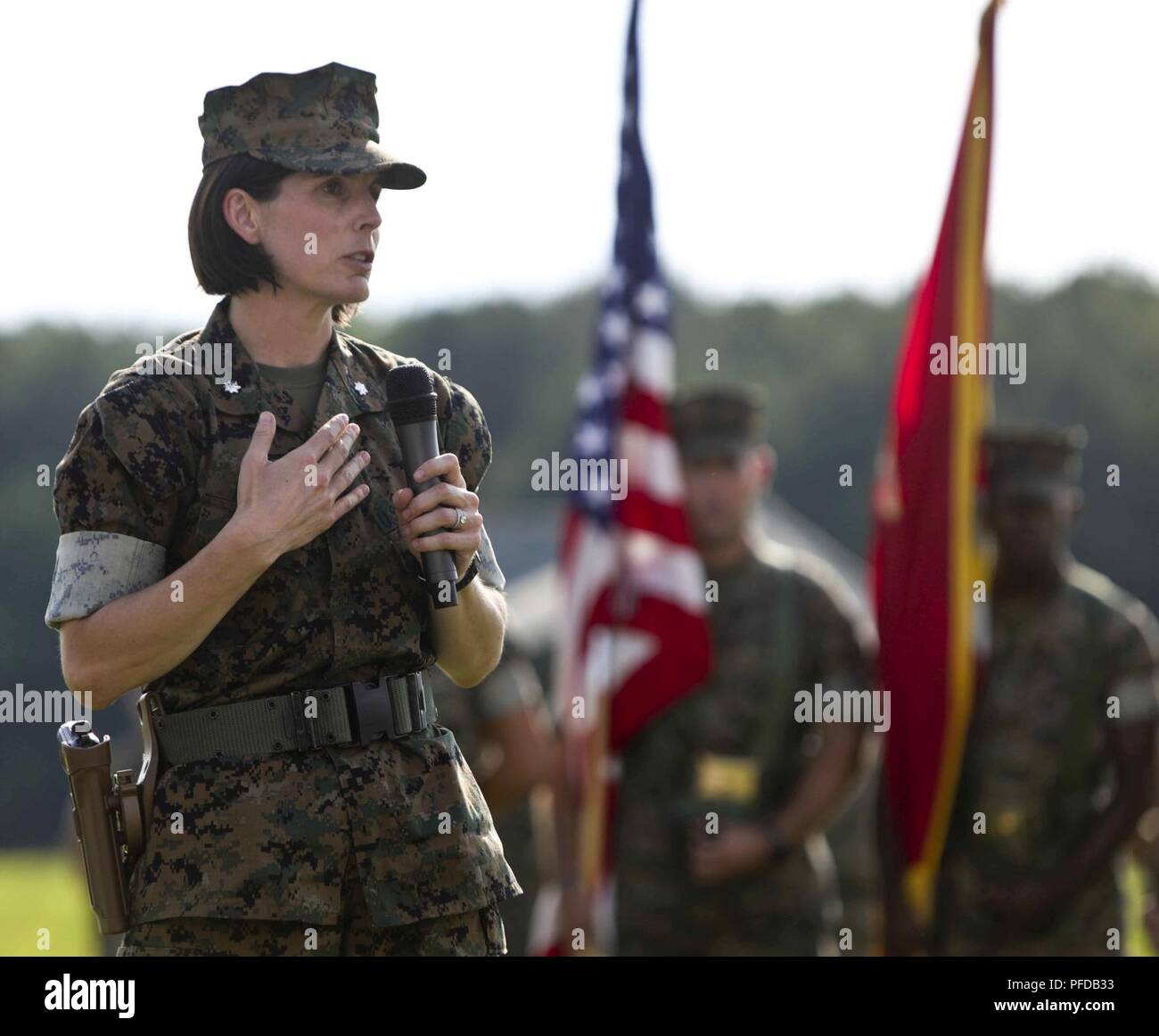 U.S. Marine Lt. Col. Amy E. Punzel the on coming commanding officer of Headquarters and Service (H&S) Battalion, School of Infantry-East, addresses Marines, Sailors, family and friends during the H&S Battalion change of command ceremony at Camp Lejeune, N.C., June 8, 2018. The change of command ceremony represents the offical passing of authority from the off going commander, Lt.Col. Kyle G. Phillips to the on coming, Lt. Col. Punzel. Stock Photo