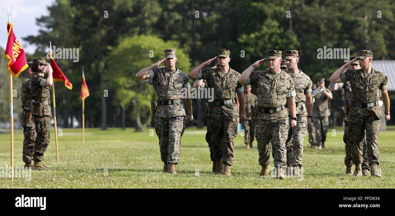 U.S. Marines assigned to Headquarters and Service (H&S) Battalion, School of Infantry-East, conduct a pass and review during the H&S Battalion change of command ceremony at Camp Lejeune, N.C., June 8, 2018. The change of command ceremony represents the offical passing of authority from the off going commander, Lt.Col. Kyle G. Phillips to the on coming, Lt. Col. Amy E. Punzel. Stock Photo