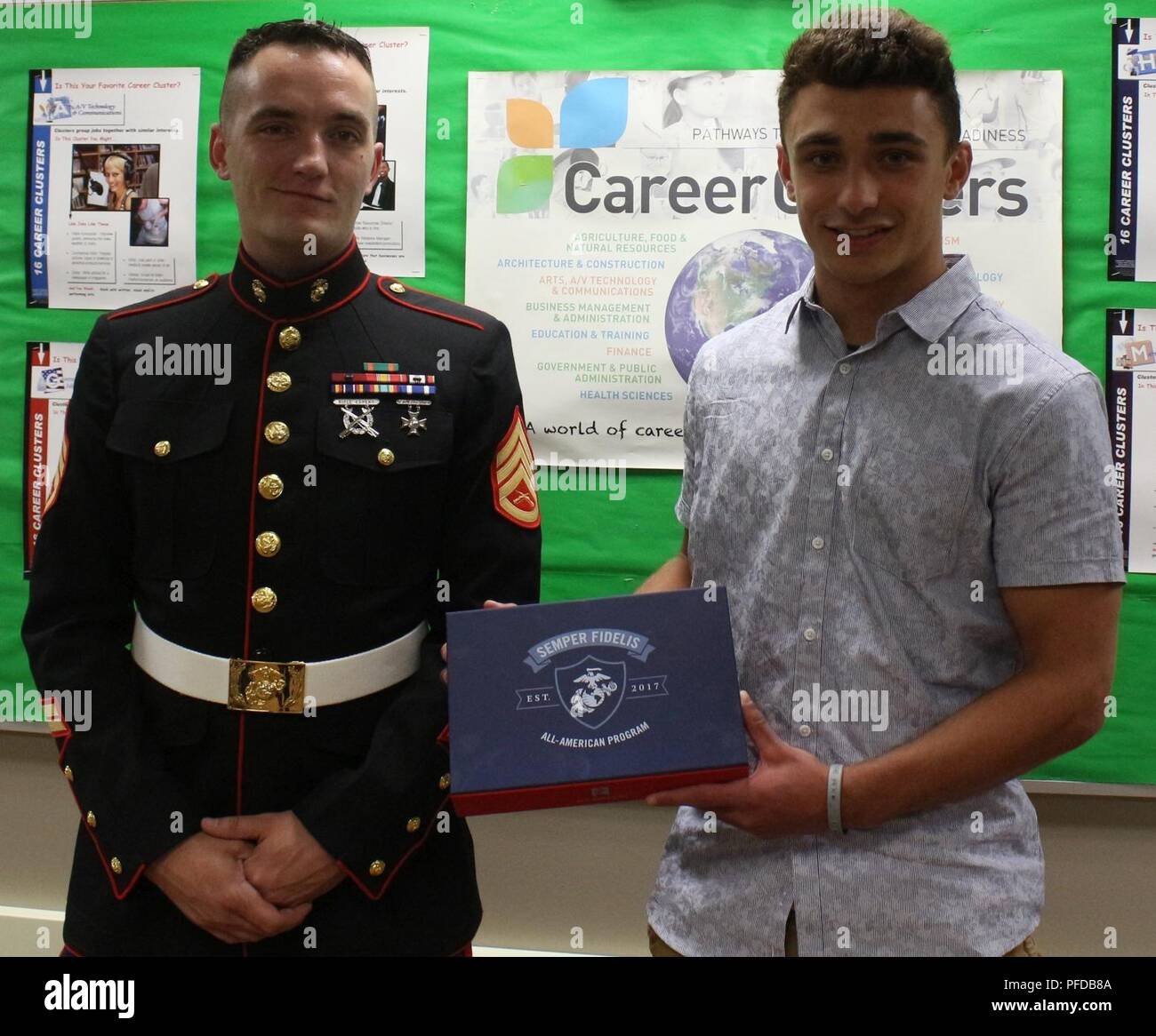 Staff Sgt. William Verrett, Recruiting Substation North Milwaukee recruiter, presented Hunter Denor, Kettle Moraine High School student, with a Semper Fi All American Program award. He will be attending the Battles Won Academy in Washington, D.C. with his mentor for a week of leadership development and teamwork building. Stock Photo