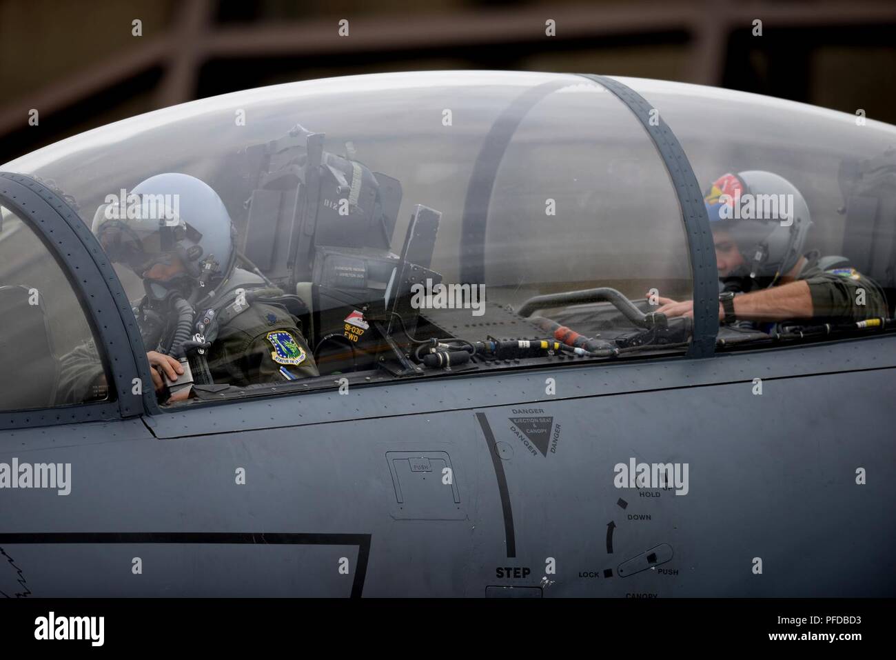 An F-15E Strike Eagle crew assigned to the 492nd Fighter Squadron conducts pre-flight checks during a readiness exercise at Royal Air Force Lakenheath, England, June 5, 2018. Exercise scenarios are designed to emphasize the importance of combat skills effectiveness training and ensure Liberty Wing Airmen are fully prepared for potential contingencies. Stock Photo