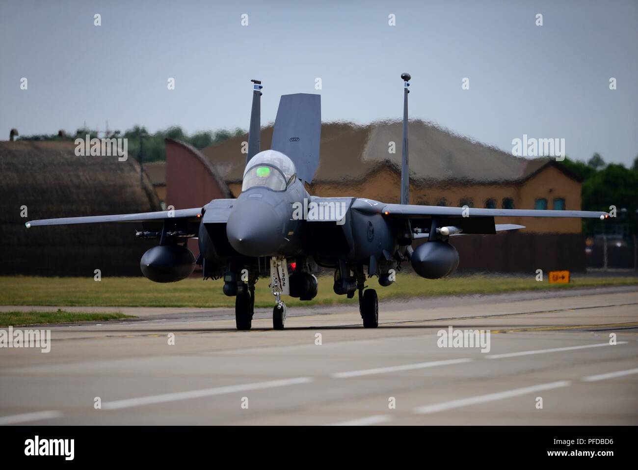 An F-15E Strike Eagle assigned to the 492nd Fighter Squadron taxis for the runway during a readiness exercise at Royal Air Force Lakenheath, England, June 5, 2018. Exercise scenarios are designed to emphasize the importance of combat skills effectiveness training and ensure Liberty Wing Airmen are fully prepared for potential contingencies. Stock Photo