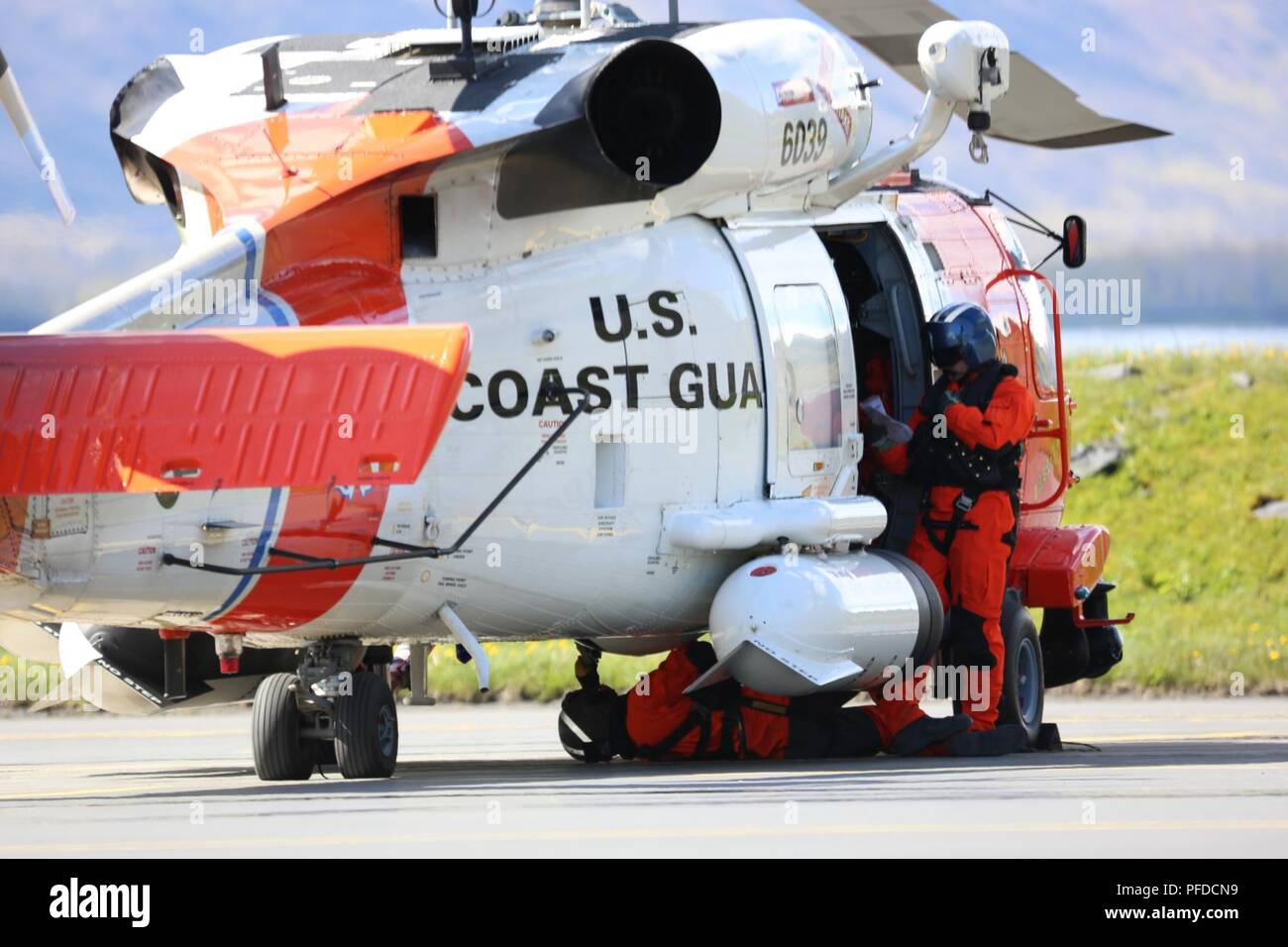 A Coast Guard aircrew conducts safety checks on the tarmac before a flight in Kodiak, Alaska, June 1, 2018. Safety checks ensure aircraft are safe for flight. U.S. Coast Guard Stock Photo