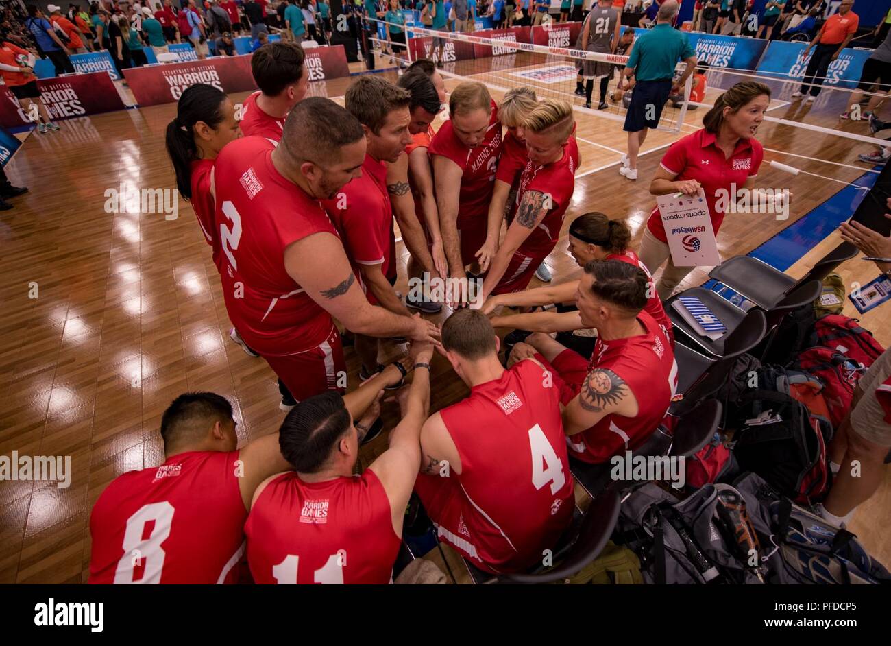 Competitors of Team Marine Corps get hyped up before their DoD Warrior Games sitting volleyball game, June 4, 2018, at the U.S. Air Force Academy in Colorado Springs, Colorado. The Warrior Games are an annual event, established in 2010, to introduce wounded, ill and injured service members to adaptive sports as a way to enhance their recovery and rehabilitation. Stock Photo