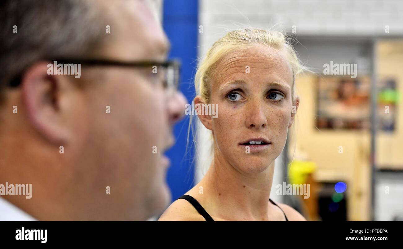 Team Air Force member Kristen Stewart talks to her coach during a Department of Defense Warrior Games swim practice at the U.S. Air Force Academy, Colorado Springs, Colorado, June 5, 2018. Team Air Force athletes competing in the Games are part of the Air Force Wounded Warrior Program, which strives to provide well-coordinated, personalized support and advocacy to every wounded, ill or injured service member who is part of the program, as well as his or her family members and caregivers. Stock Photo