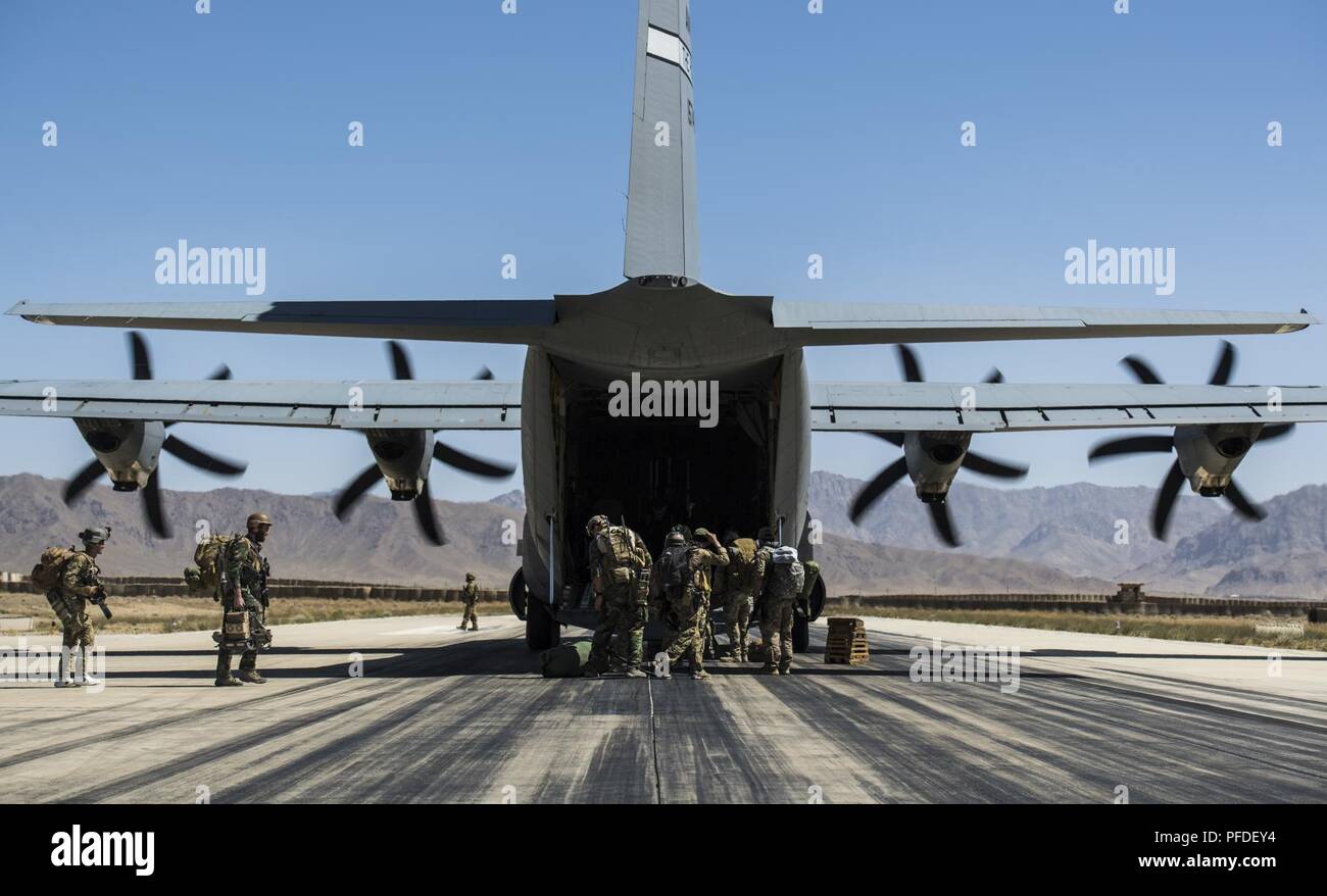 Passengers get in line to get on board of a C-130J Super Hercules assigned to the 455th Air Expeditionary Wing at Bagram Airfield, Afghanistan, on May 30, 2018 at Forward Operating Base Shank, Afghanistan. The C-130J can accommodate an estimate of 90 military personnel. One of its capabilities is to transport troops to forward operating locations throughout the U.S. Central Command area of responsibility in support of different Operations. Stock Photo