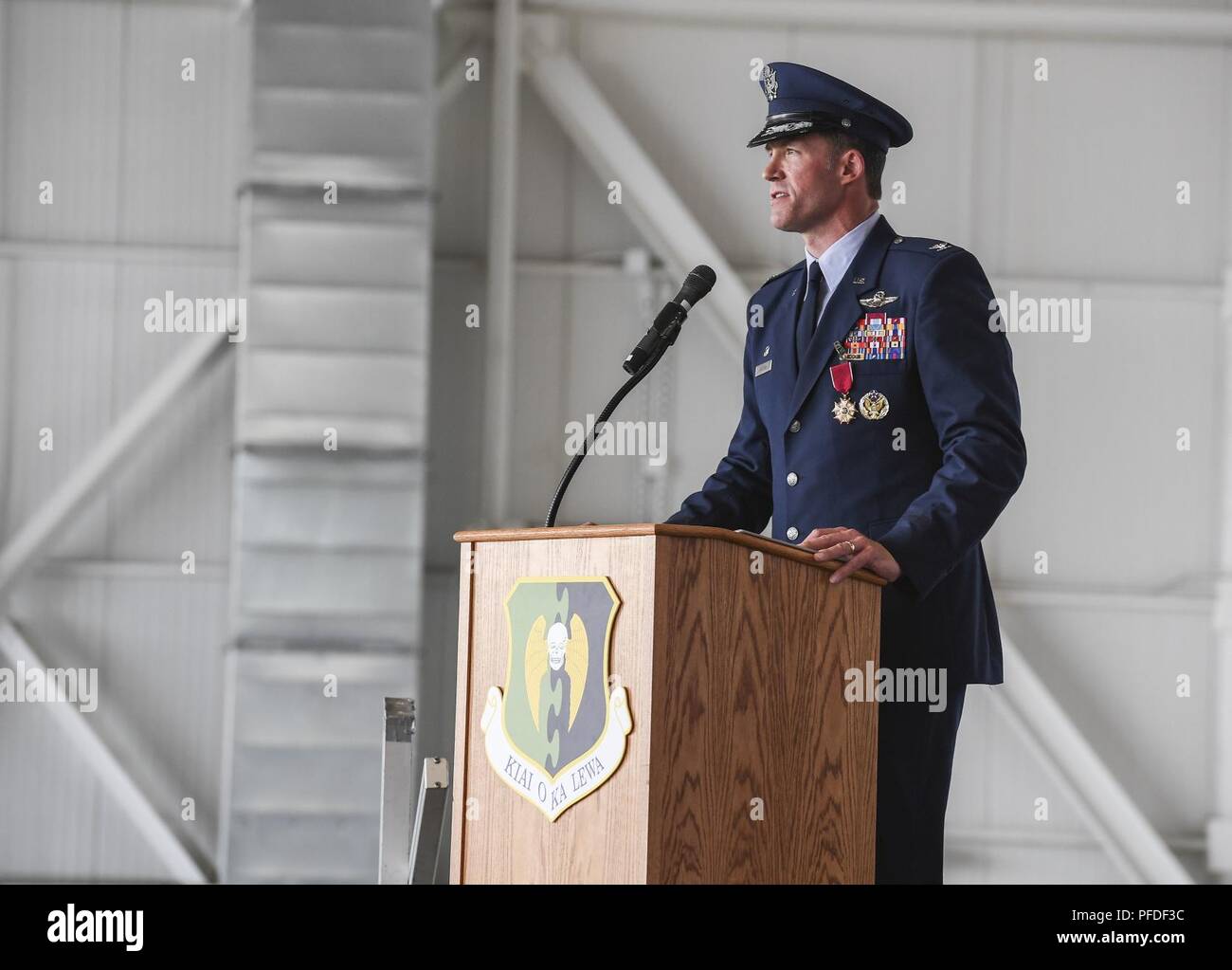 Col. Matthew Brooks, former 5th Bomb Wing commander, speaks to Team Minot Airmen during a change