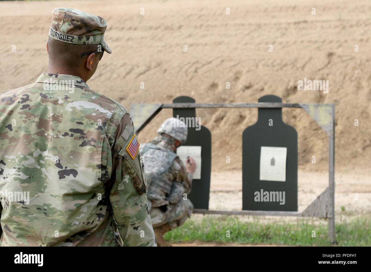 U.S. Army Reserve Sgt. 1st Class Louis Rodriguez, a senior drill sergeant with the 98th Training Division (Initial Entry Training) out of Sacramento California, watches over a Soldier as he marks his target at the Zero Range during the 2018 U.S. Army Reserve Best Warrior Competition at Fort Bragg June 10.  More than 35 Soldiers representing seven Geographic Commands and 22 Functional Commands, will spend the week competing in a variety of challenges including firing weapons, land navigation, the Army Physical Fitness Test, and various mystery events. These challenges will ultimately test their Stock Photo