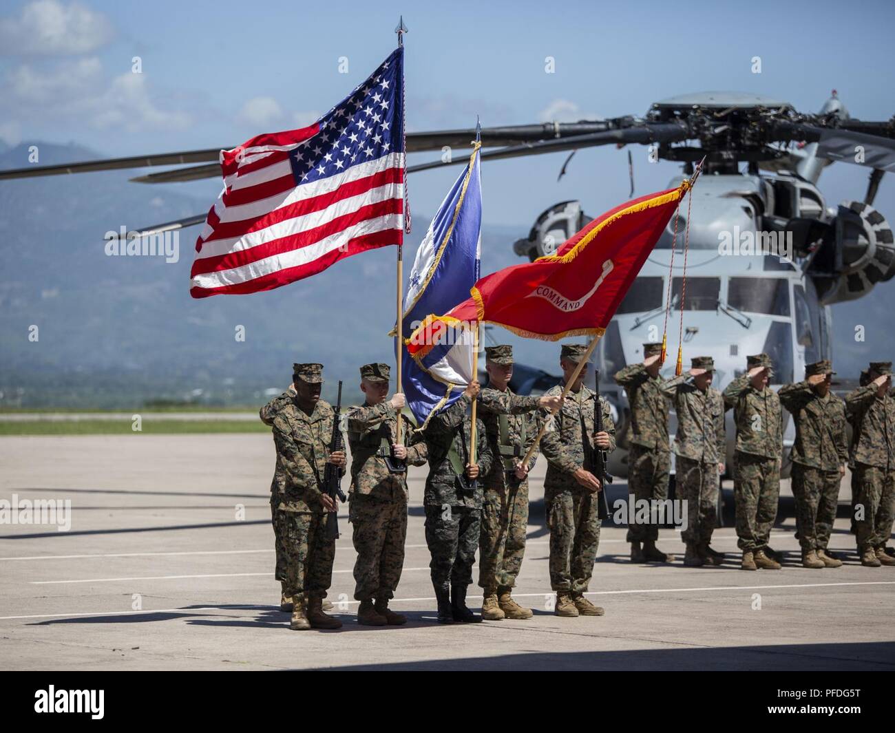 A multinational color guard comprised of Marines with Special Purpose Marine Air-Ground Task Force - Southern Command and a Honduran Army soldier present colors during an opening ceremony on Soto Cano Air Base, Honduras, to mark the beginning of SPMAGTF-SC deployment to Latin America and the Caribbean, June 11, 2018. The Marines and sailors of SPMAGTF-SC will conduct security cooperation training and engineering projects alongside partner nation military forces in Central and South America during their deployment. The unit is also on standby to provide humanitarian assistance and disaster reli Stock Photo