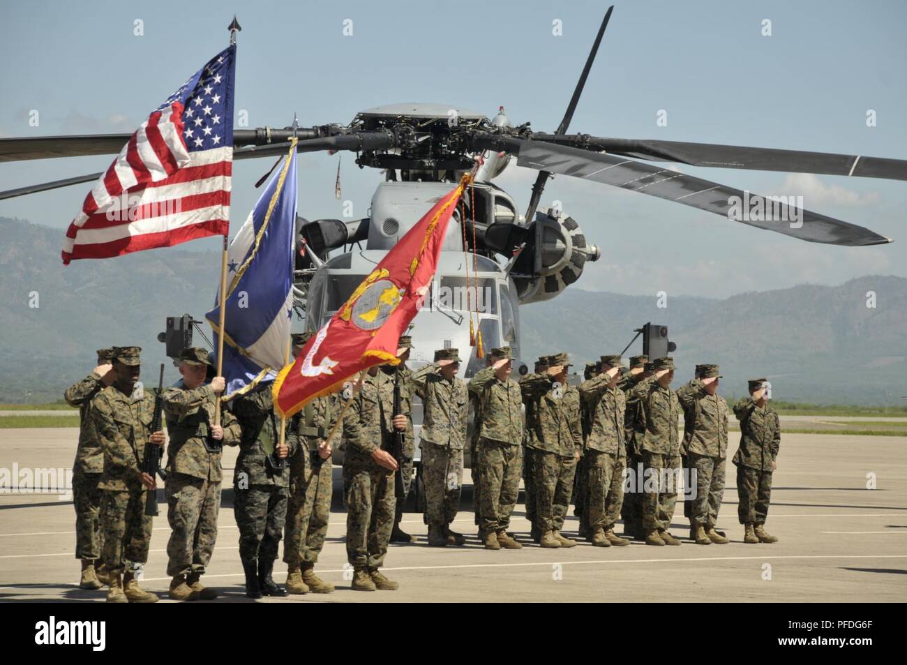 A multinational color guard comprised of Marines with Special Purpose Marine Air-Ground Task Force - Southern Command and a Honduran Army soldier present colors during an opening ceremony on Soto Cano Air Base, Honduras, to mark the beginning of SPMAGTF-SC deployment to Latin America and the Caribbean, June 11, 2018. The Marines and sailors of SPMAGTF-SC will conduct security cooperation training and engineering projects alongside partner nation military forces in Central and South America during their deployment. The unit is also on standby to provide humanitarian assistance and disaster reli Stock Photo