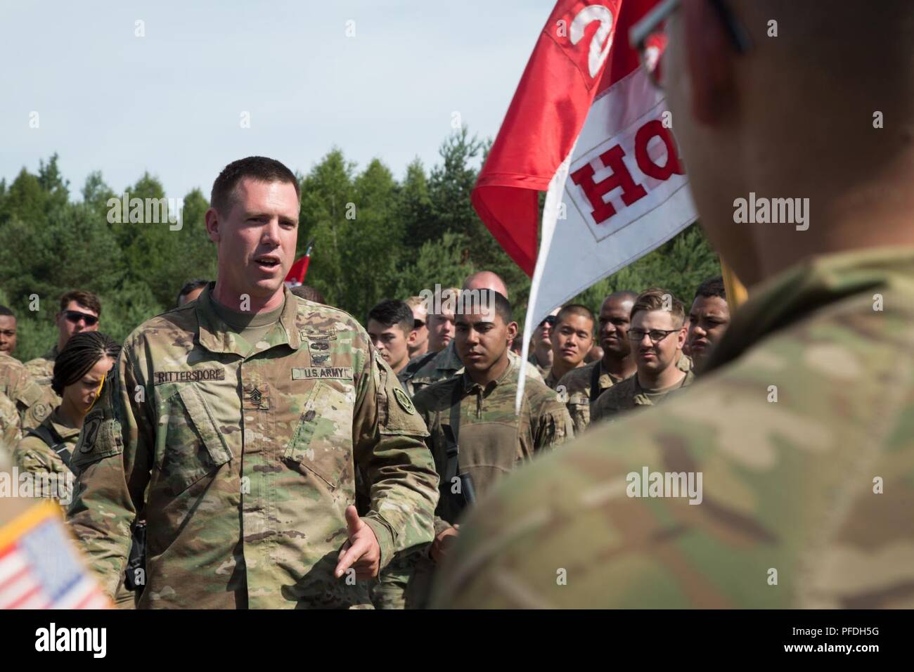 1st Sgt. William D. Rittersdorf, first sergeant, Headhunter Troop, 2nd Squadron, 2d Cavalry Regiment, talks to his squadron in Kazlu Ruda, Lithuania, June 10, 2018. U.S. Army Europe’s exercise Saber Strike 18 promotes regional stability and security, while strengthening partner capabilities and fostering trust; the combined training opportunities that it provides greatly improve interoperability among participating NATO allies and key regional partners. Stock Photo
