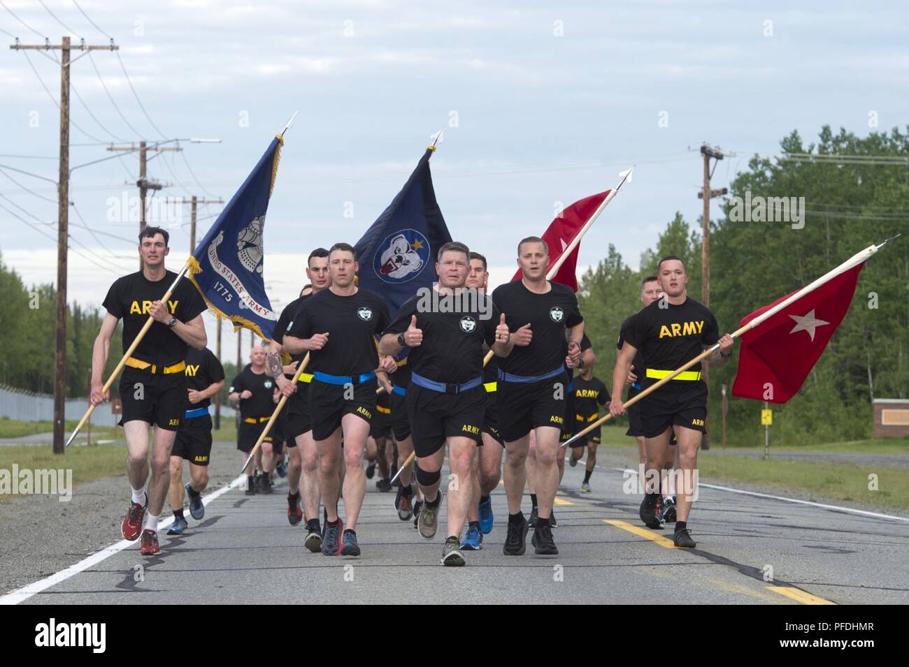 U.S. Army Alaska Commanding General, Maj. Gen. Mark J. O’Neil, center, leads the Soldiers of USARAK on a large formation run celebrating the Army’s 243rd birthday at Joint Base Elmendorf-Richardson, Alaska, June 13, 2018. Following the run the USARAK commanding general and command sergeant major cut a birthday cake with the youngest and oldest Soldiers present at JBER. Stock Photo