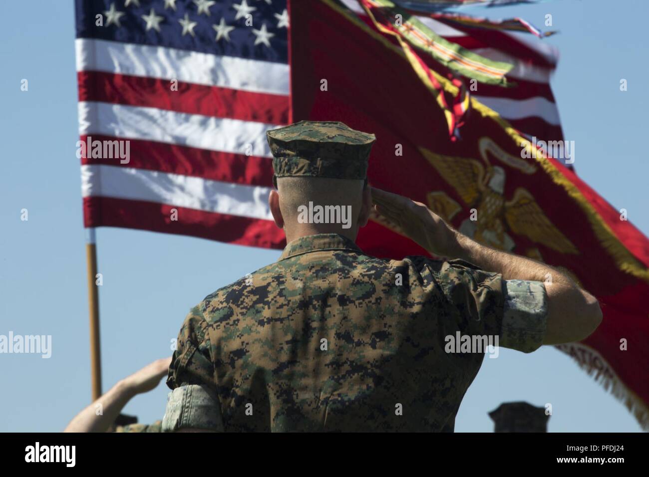 Col. Scott A. Gondek, commanding officer of Marine Air Control Group 48, salutes the American flag as “Star Spangled Banner” plays during Marine Wing Communications Squadron (MWCS) 48’s change of command ceremony at Marine Corps Air Station Miramar, Calif., June 13. Lt. Col. Brian C. Pate assumed command of MWCS-48 from Lt. Col. Michael E. Sheridan who received a Meritorious Service Medal for his time as MWCS-48’s commanding officer. Stock Photo