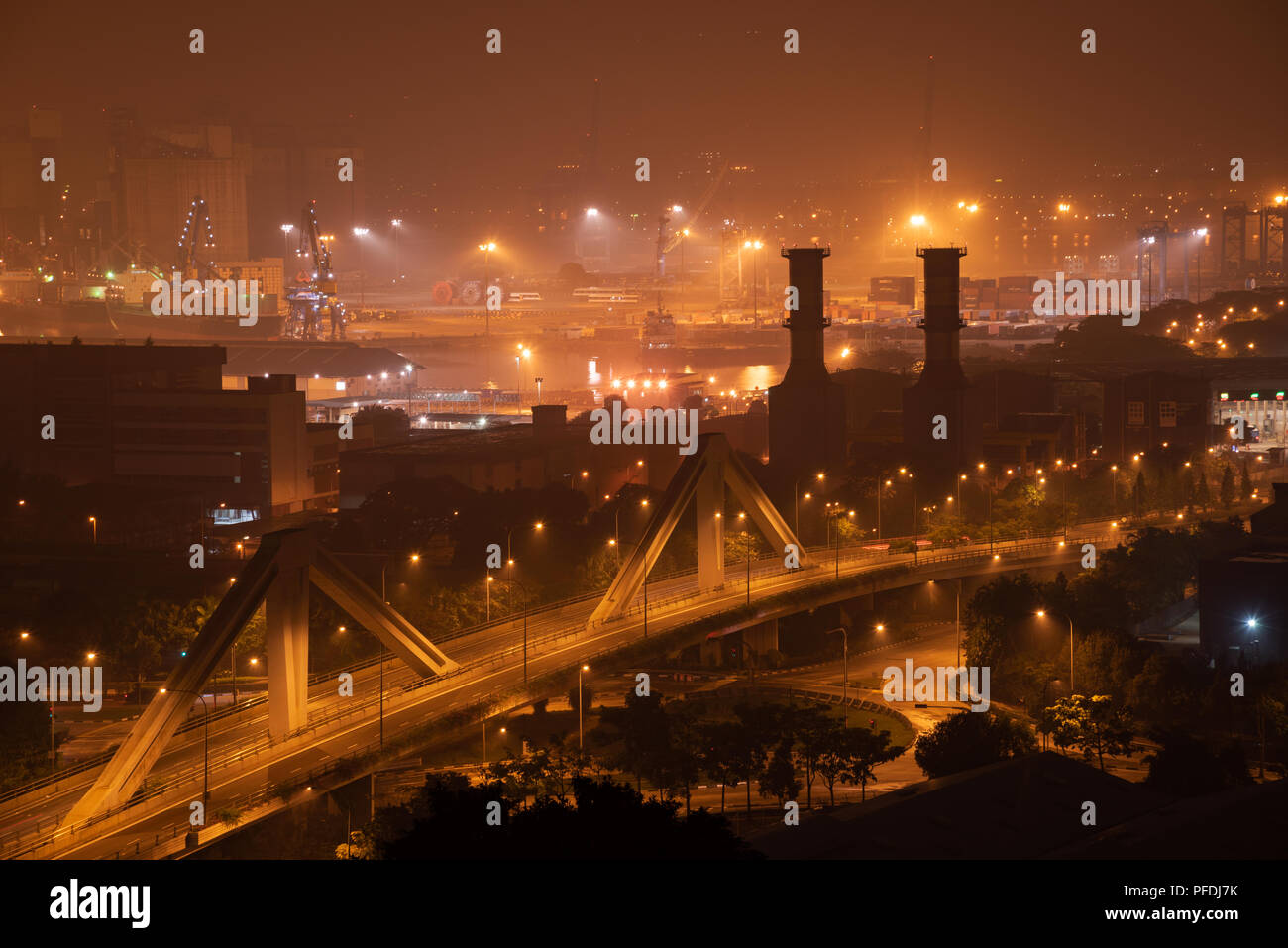 Port operations during a hazy night, Singapore Stock Photo