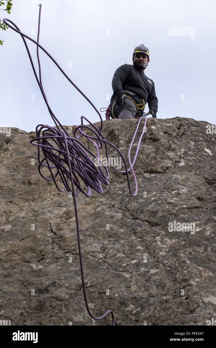 Christian Ortega, an Outdoor Adventure Program recreational assistant, throws climbing rope down after an OAP rock-climbing trip at Pivot Point Trail near Anchorage, Alaska, May 31, 2018. Ortega has been climbing for more than five years and has and internship with OAP on guided events and classes. The OAP offers low-cost opportunities for the Joint Base Elmendorf-Richardson community to explore Alaska while also supporting the development of mission-ready military members. Stock Photo