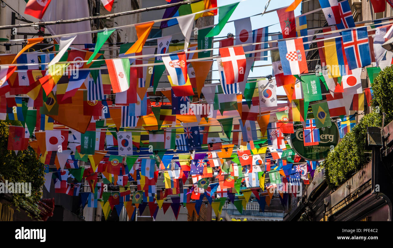 world flags flying on small banners above the streets of Dublin during world cup 2018 in June. Stock Photo
