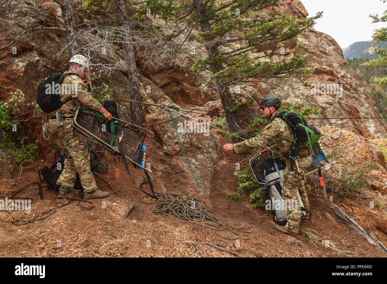 Green Berets, assigned to 10th Special Forces Group (Airborne), prepare to haul rescue equipment across a canyon using a rope system during personnel recovery training at Cheyenne Canyon, Colo., June 6, 2018.  Special Forces mountaineers routinely practice various mountain operations in difficult terrain in order to maintain proficiency for real world contingencies. Stock Photo