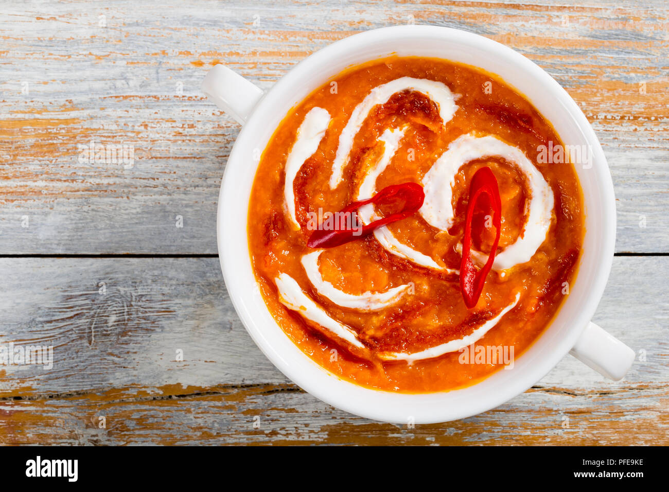 spicy delicious asian Pumpkin Soup with red thai paste, chilli slices