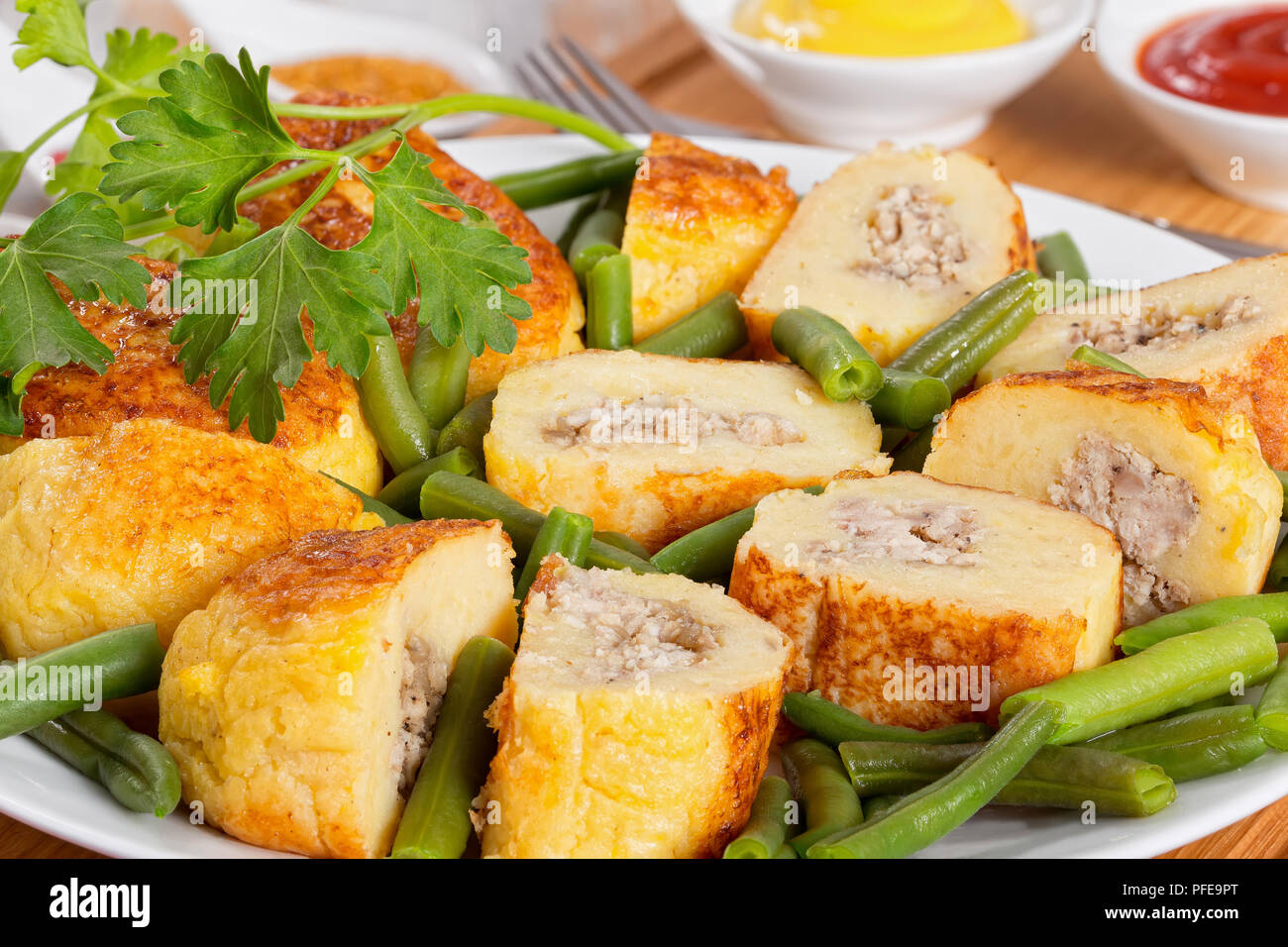 Delicious Italian Potato Pancakes From Mashed Potato Filled With Ground Chicken Meat With Green Beans On White Platter Mustard And Tomato Sauce On B Stock Photo Alamy