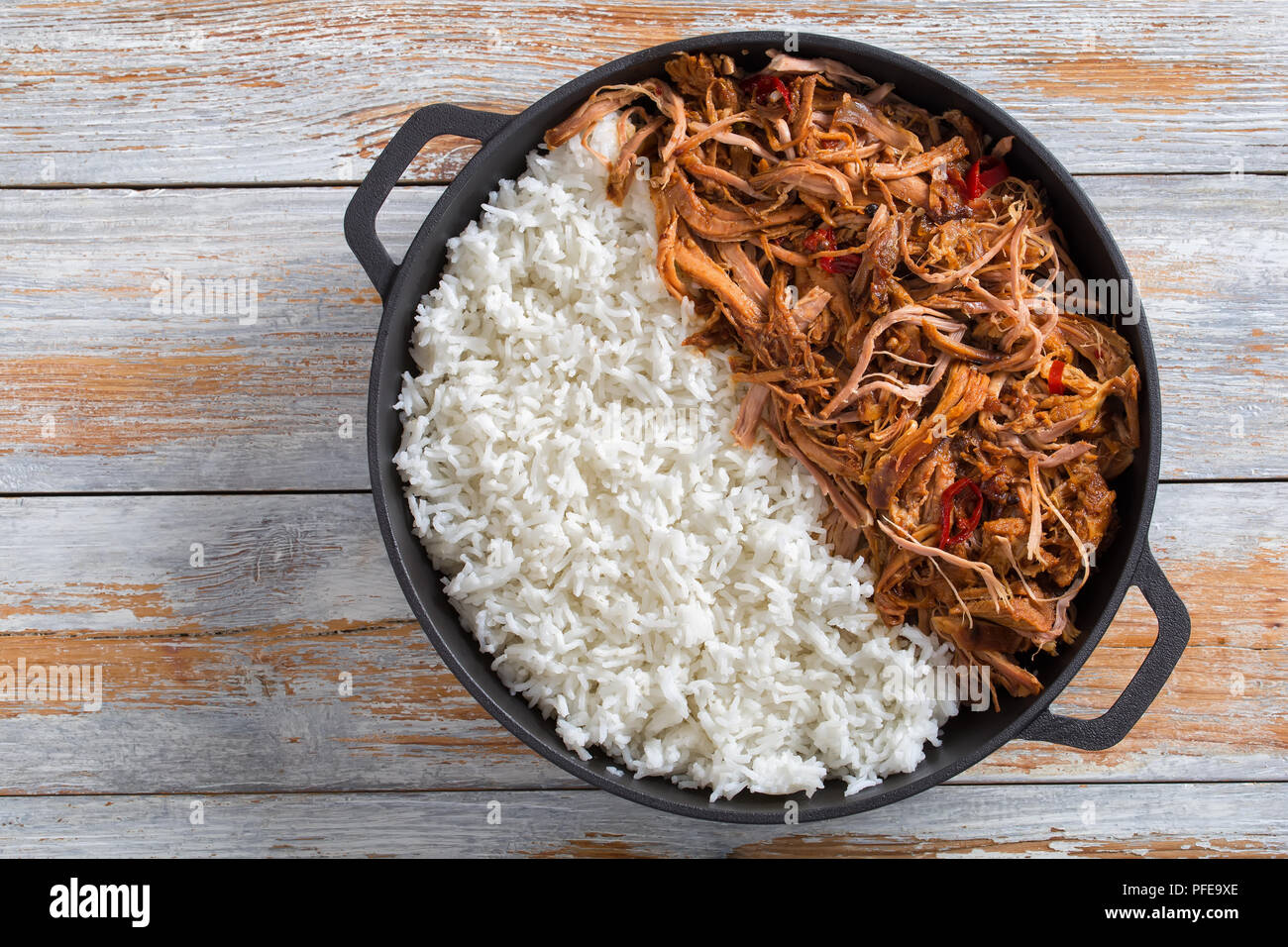 pulled slowcooked pork shoulder grilled in oven with basmati rice in
