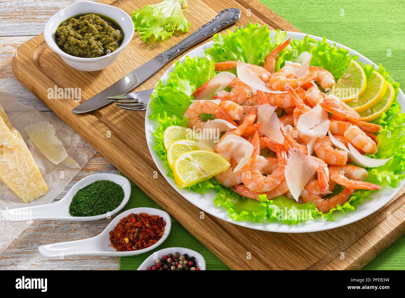 delicious fresh salad with prawns, green lettuce, slices of parmesan