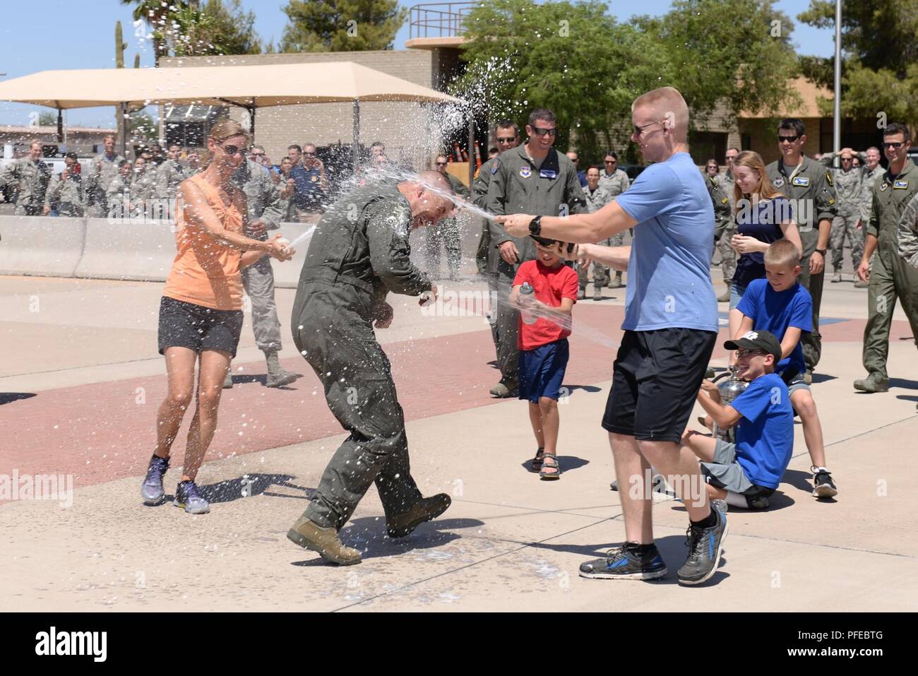 Brig. Gen. Brook Leonard, 56th Fighter Wing commander, is showered by his family in celebration of his final sortie at Luke Air Force Base, Ariz., June 8, 2018. A pilot’s final flight at an assignment is an occasion steeped in tradition and celebration. Stock Photo