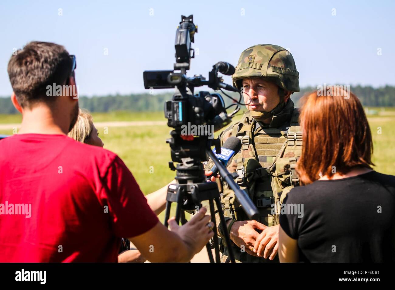 Polish Brig. Gen. Jarosław Gromadziński, 15th Mechanized Brigade commander, is interviewed by local media during the opening ceremony of Saber Strike 18 with Battle Group Poland at Wierzbiny, Poland, June 4, 2018. Saber Strike is a multinational exercise currently in its eighth year. This year's exercise, which runs from June 3-15, tests allies and partners from 19 countries on their ability work together to deter aggression in the region and improve each unit's ability to perform their designated mission. Stock Photo