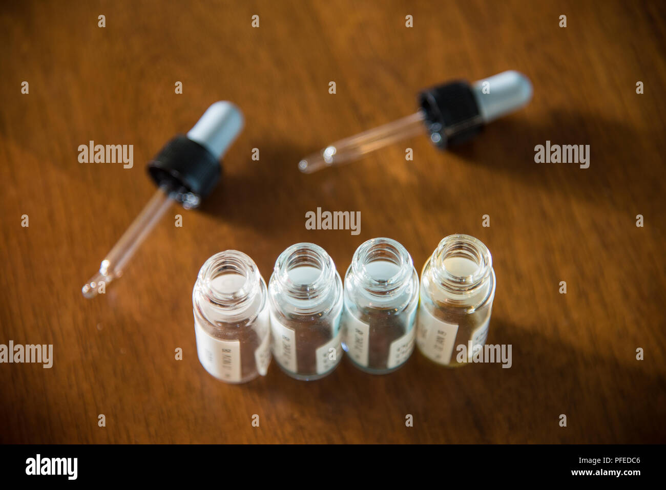 Laboratory glass items adding drop to one of several test tubes. A scientific experiment in a