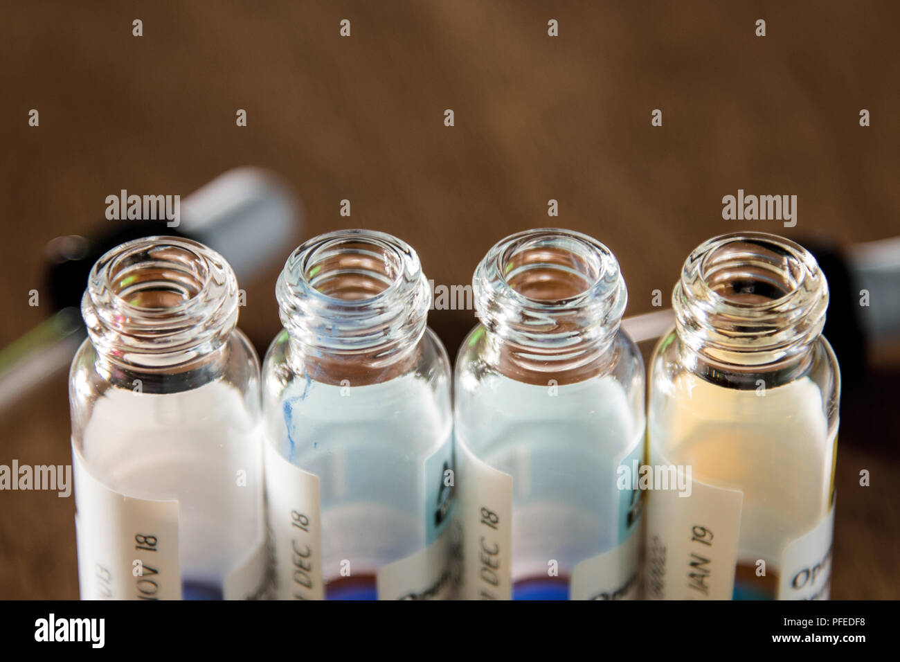 Laboratory glass items adding drop to one of several test tubes. A scientific experiment in a