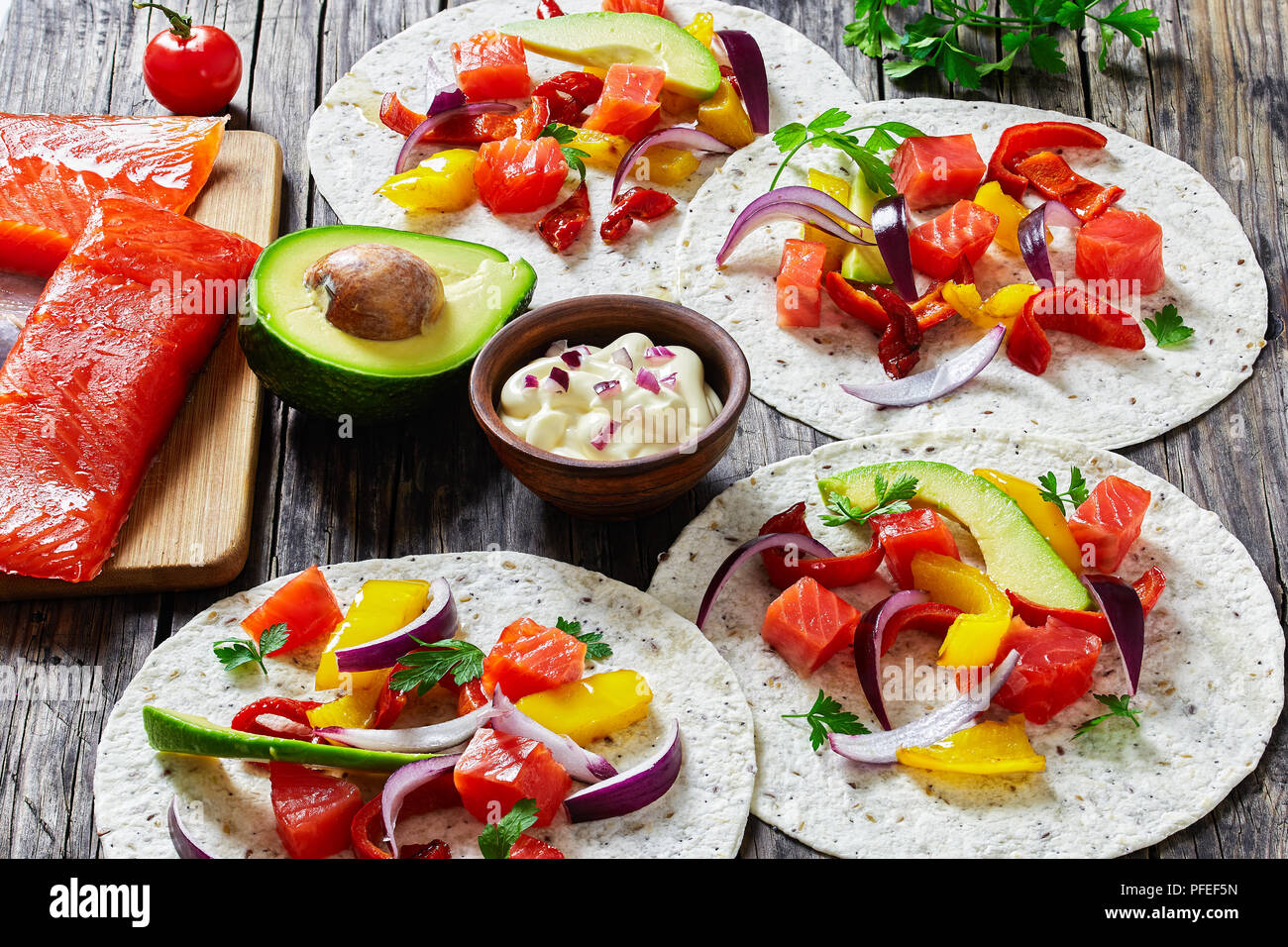 delicious healthy fajitas with chunks of smoked salmon fish, avocado