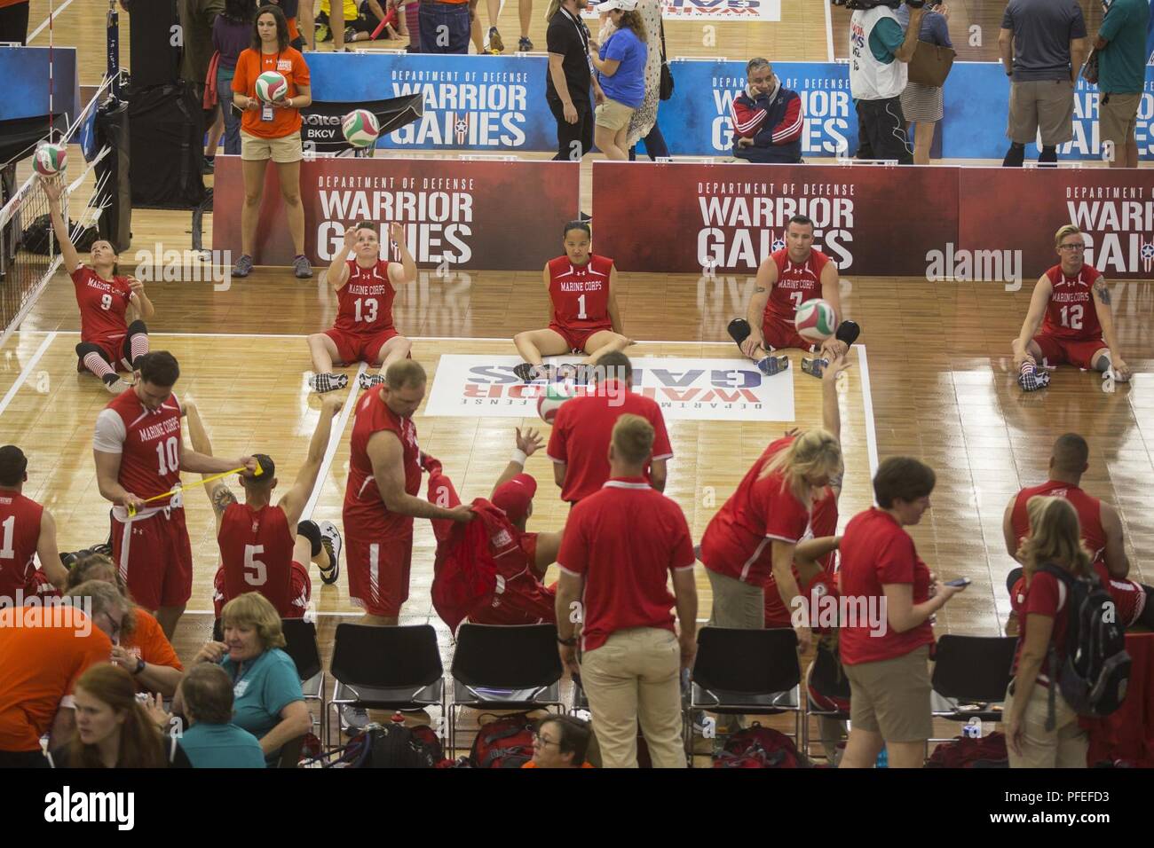 Team Marine Corps prepares for a 2018 DoD Warrior Games sitting volleyball preliminary match against Team SOCOM at the Air Force Academy in Colorado Springs, Colorado, June 3, 2018. The Warrior Games is an adaptive sports competition for wounded, ill and injured service members and veterans. Approximately 300 athletes representing teams from the Marine Corps, Navy, Army, Air Force, Special Operations Command, United Kingdom Armed Forces, Canadian Armed Forces, and the Australian Defence Force will compete June 1 - June 9 in archery, cycling, track, field, shooting, sitting volleyball, swimming Stock Photo