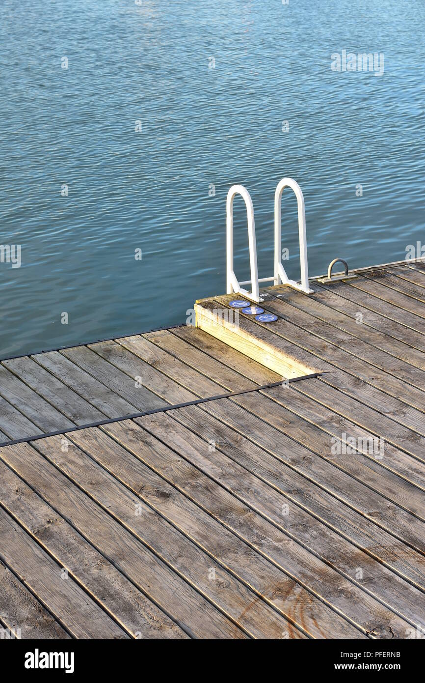 Empty Floating Pontoon With Wooden Slate Floor And Metal Ladder Railing Painted White Stock Photo Alamy