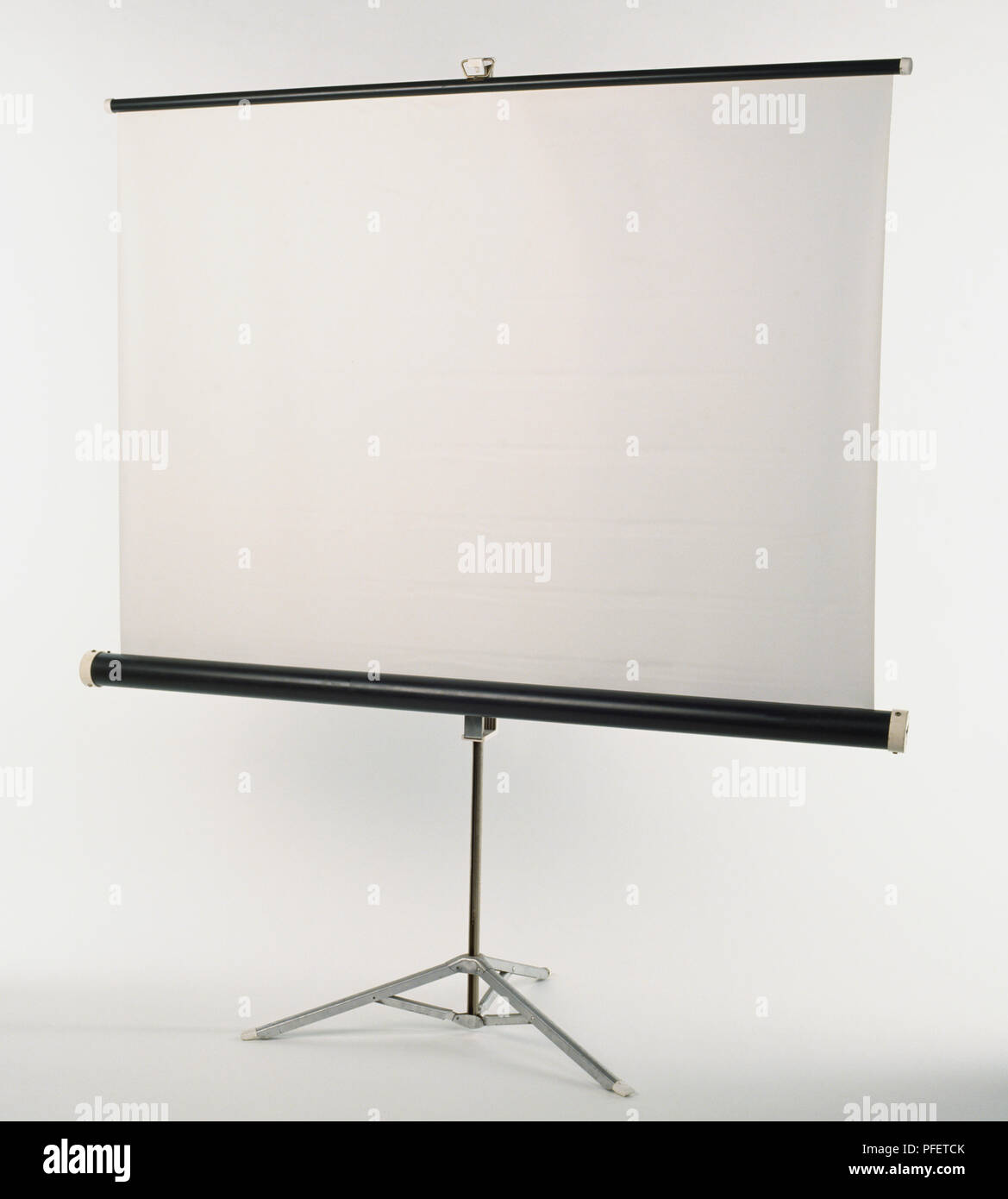 A white projector screen on a stand. Stock Photo