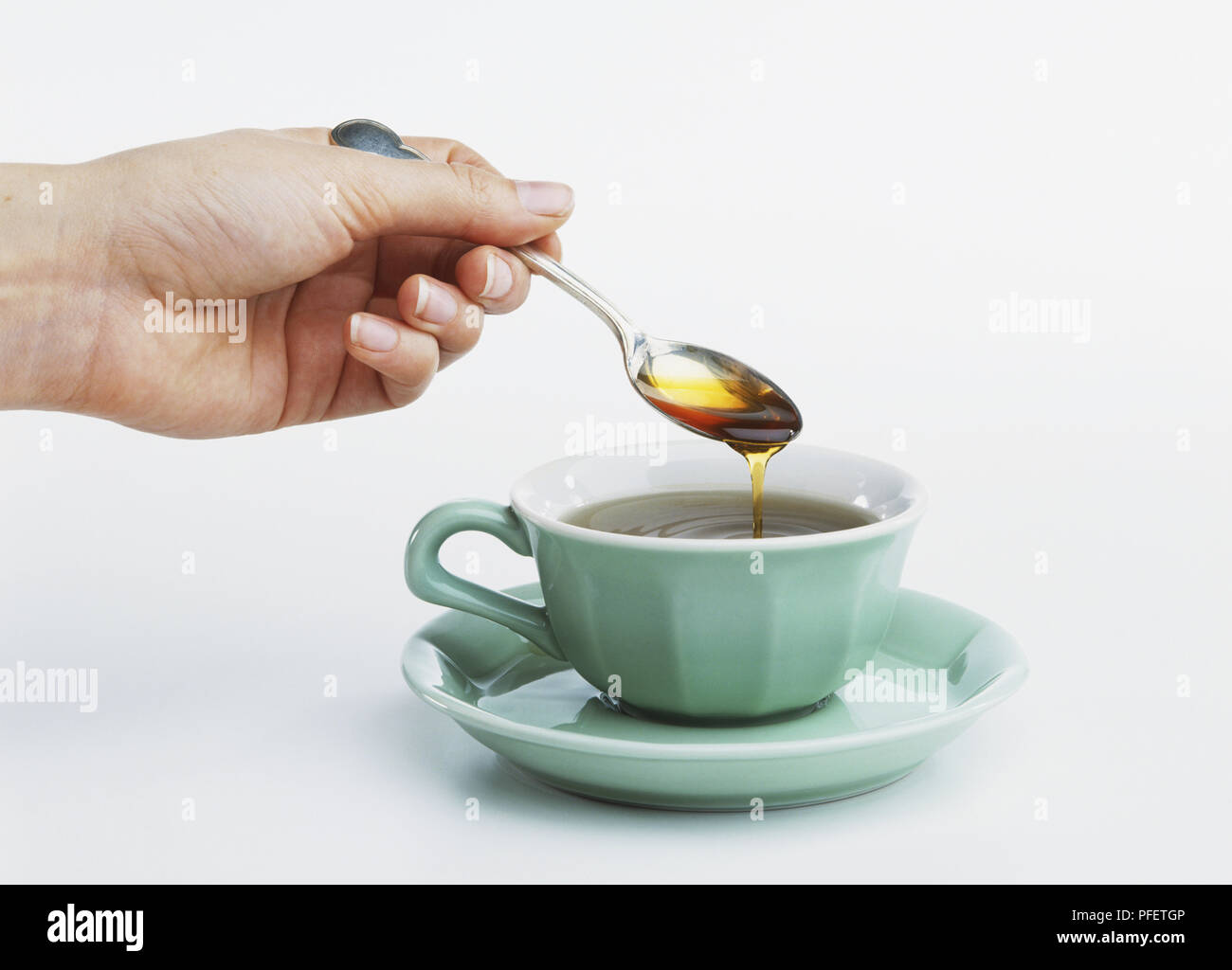 Adding A Teaspoon Of Honey To A Cup Of Tea Stock Photo Alamy