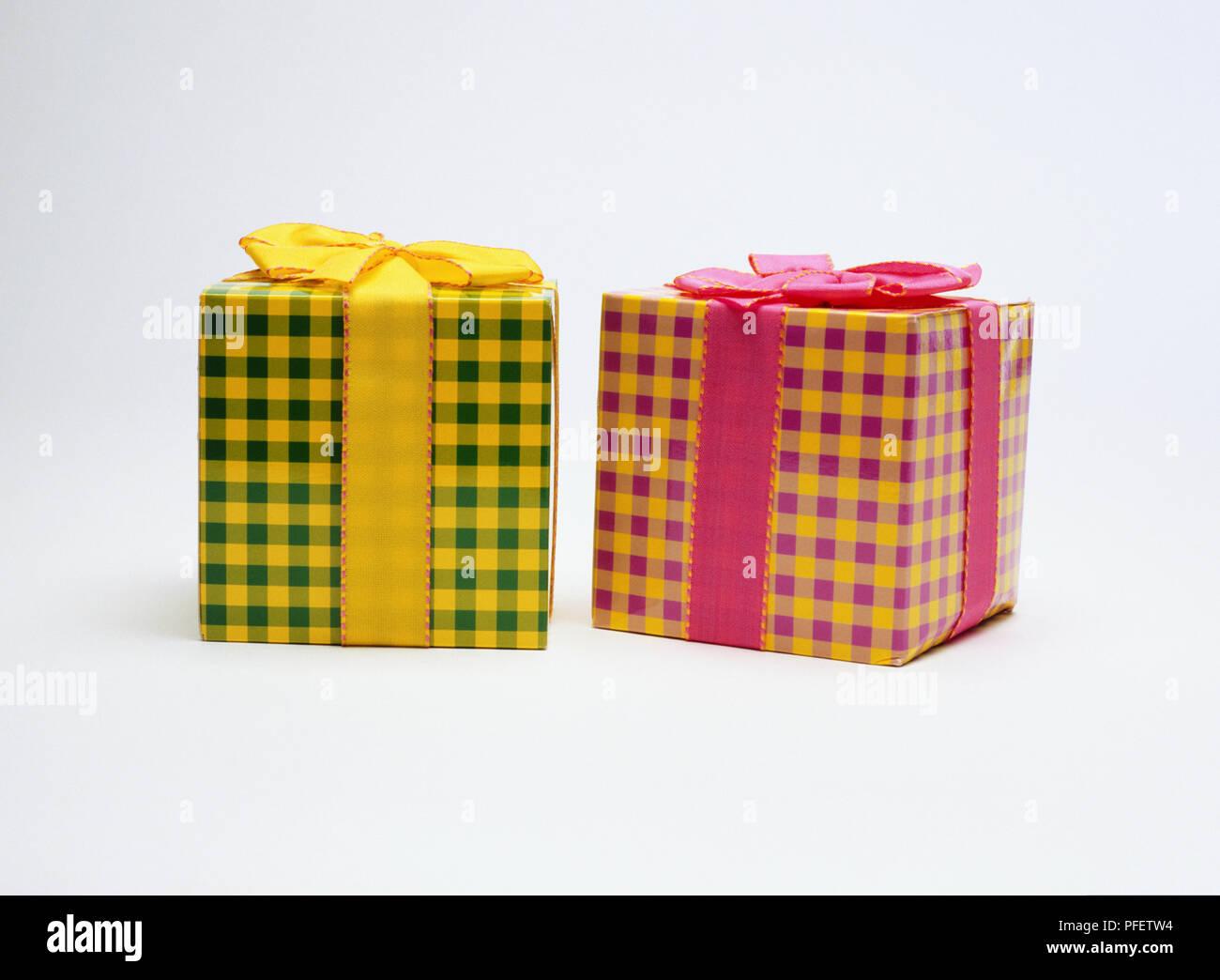 Two boxes, wrapped in chequered material, ribbons Stock Photo - Alamy