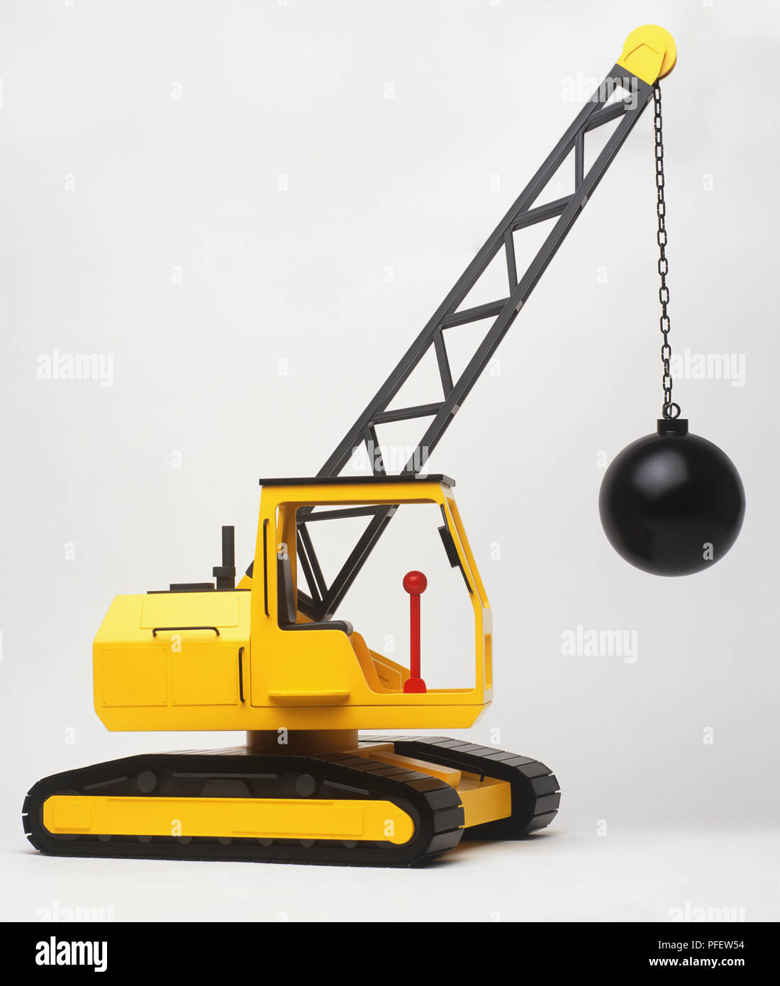 Toy crane with a demolition ball hanging from the arm. Stock Photo