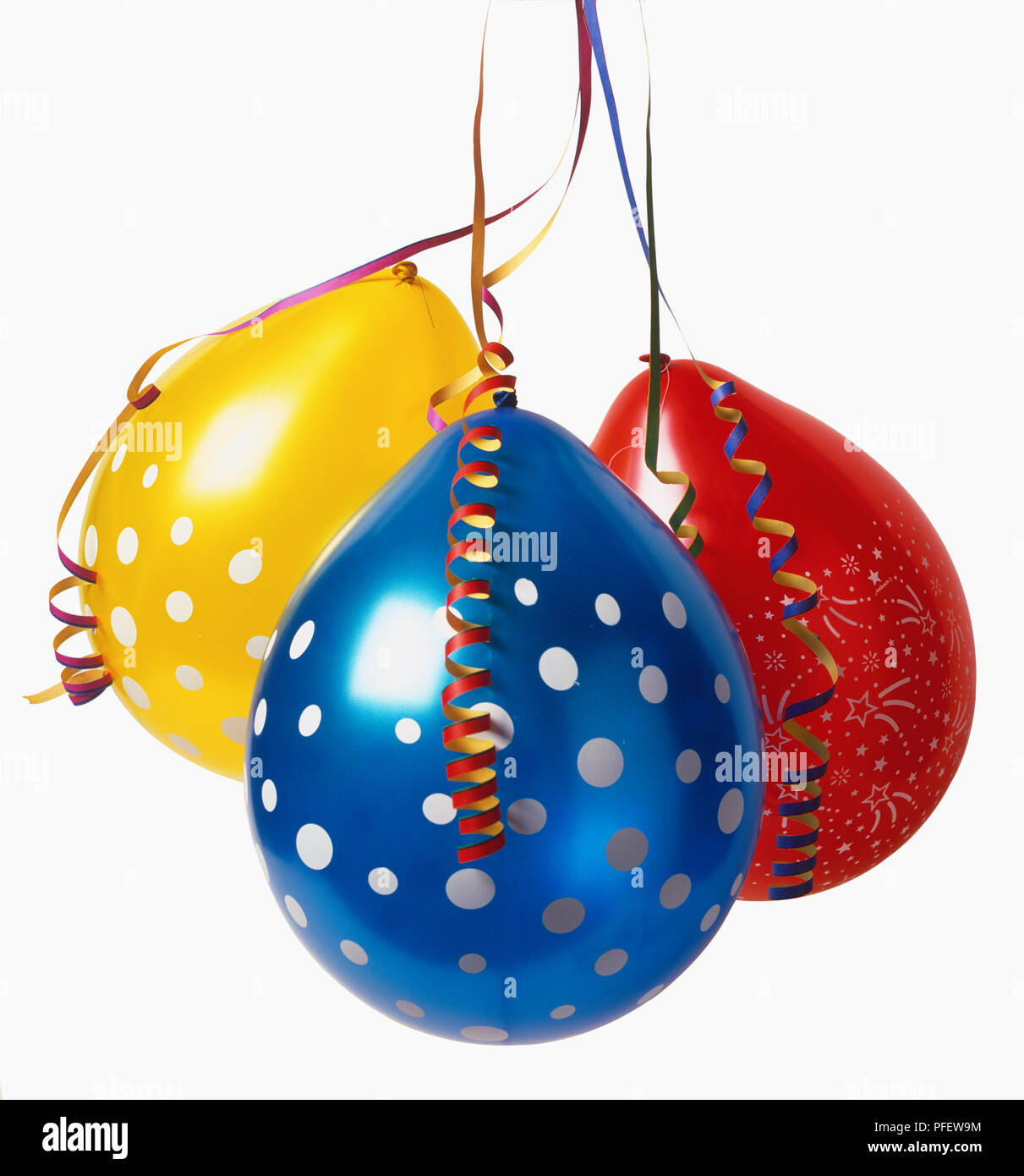 Red, yellow and blue balloons and curled ribbons. Stock Photo
