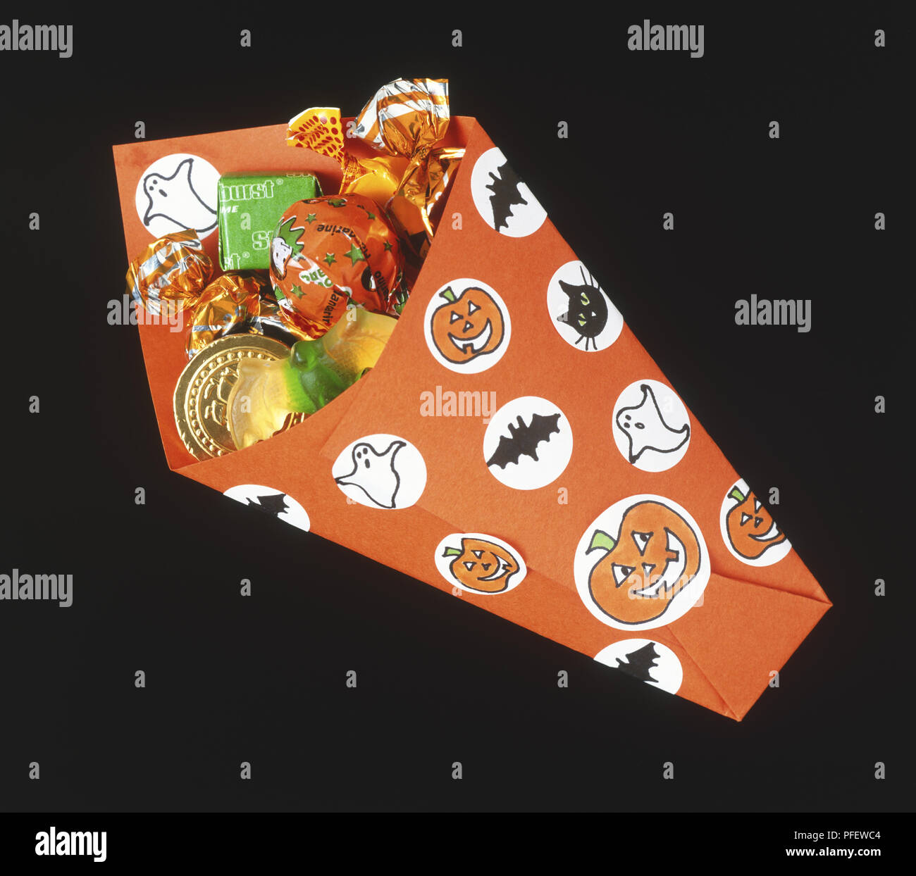 Wrapped sweets inside illustrated Halloweenthemed paper envelope Stock Photo Alamy