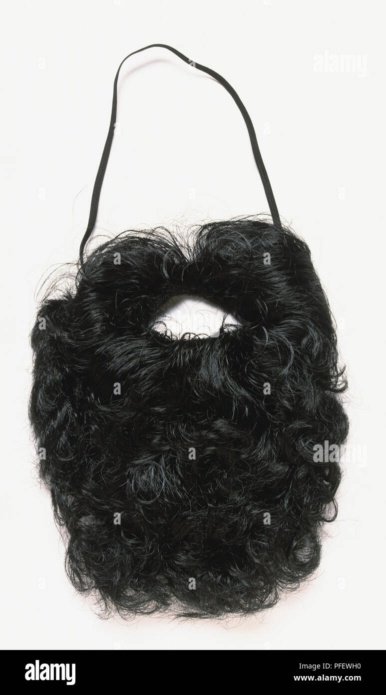 Artificial black beard and moustache, curly hairs, black elastic for attaching, front view. Stock Photo