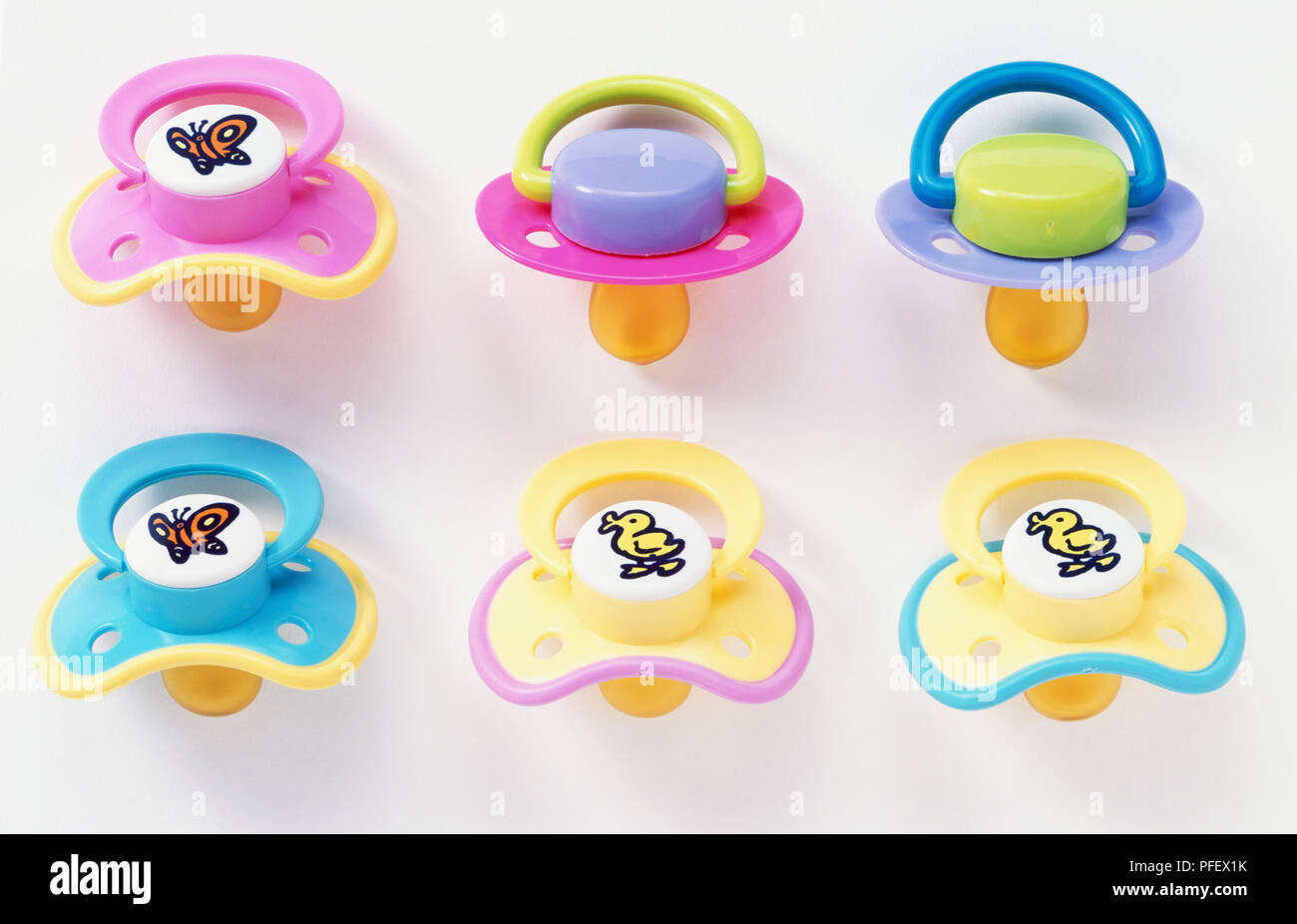 Six colourful baby dummies, close up Stock Photo Alamy