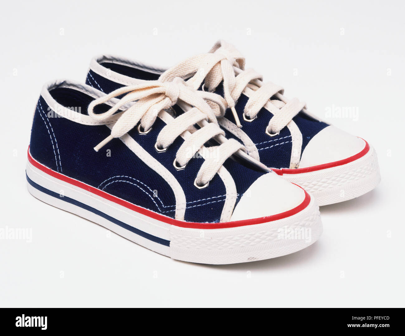 Pair of dark blue trainers with laces tied Stock Photo