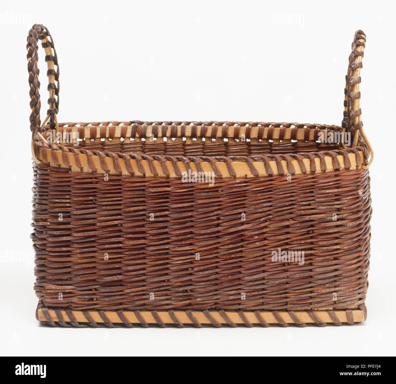 Rectangular brown wicker basket with two handles Stock Photo