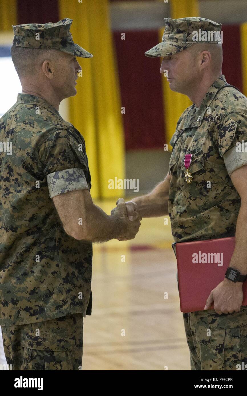 U.S. Marine Corps Maj. Gen. John K. Love, left, the Commanding General of 2nd Marine Division, and Col. Matthew S. Reid, right, the outgoing commanding officer of 6th Marine Regiment, 2nd Marine Division, shake hands during a change of command ceremony at Camp Lejeune, N.C., June 12, 2018. During the ceremony, Reid relinquished command of 6th Marine Regiment to Col. Daniel T. Canfield Jr. Stock Photo