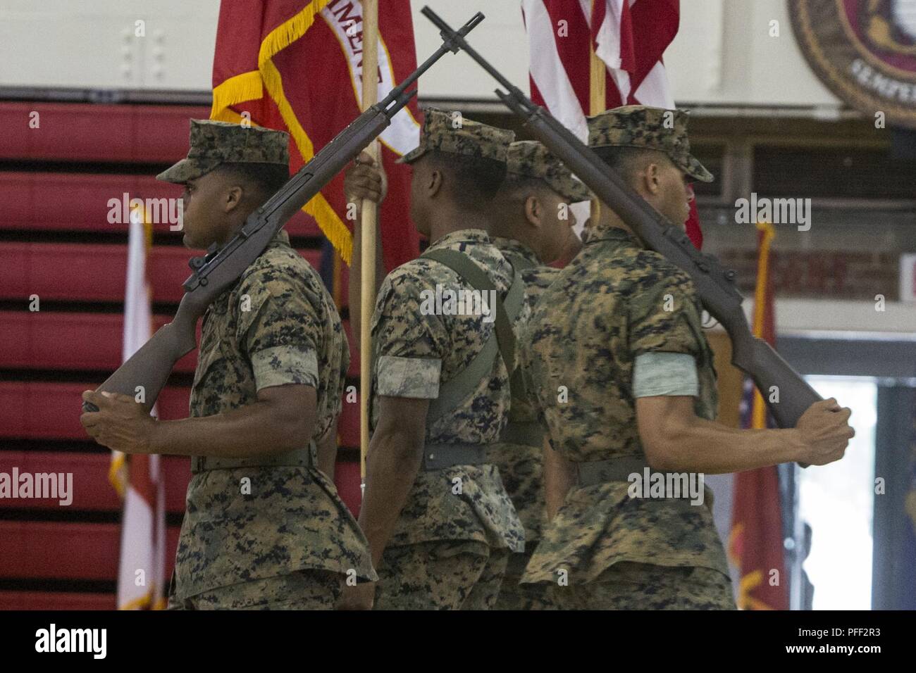 U.S. Marines with 6th Marine Regiment, 2nd Marine Division, march the colors during a change of command ceremony at Camp Lejeune, N.C., June 12, 2018. During the ceremony, Col. Matthew S. Reid relinquished command of 6th Marine Regiment to Col. Daniel T. Canfield Jr. Stock Photo
