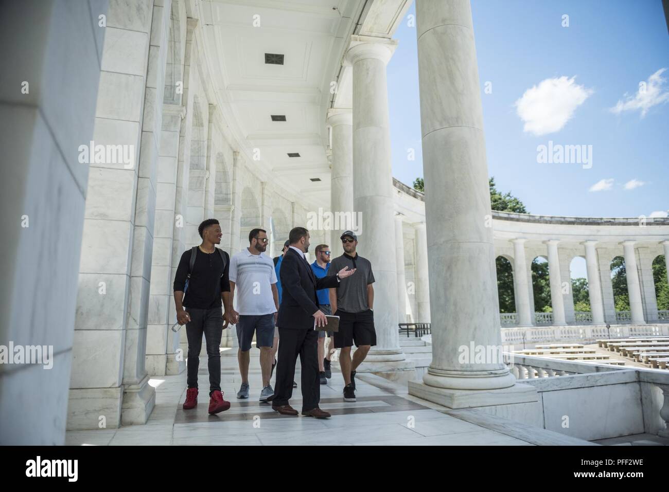 Micheal Migliara (center), events & ceremonies director, Arlington National Cemetery; talks with Detroit Lions players (from left to right) Marvin Jones Jr., Don Muhlbach, T.J. Lang, and Matthew Stafford inside of the Memorial Amphitheater at Arlington National Cemetery, Arlington, Virginia, June 12, 2018. The Lions visited Arlington National Cemetery to participate in an educational staff ride where they spoke with cemetery representatives, field operations, received a tour of the Memorial Amphitheater Display Room from ANC historians, and watched the Changing of the Guard Ceremony at the Tom Stock Photo