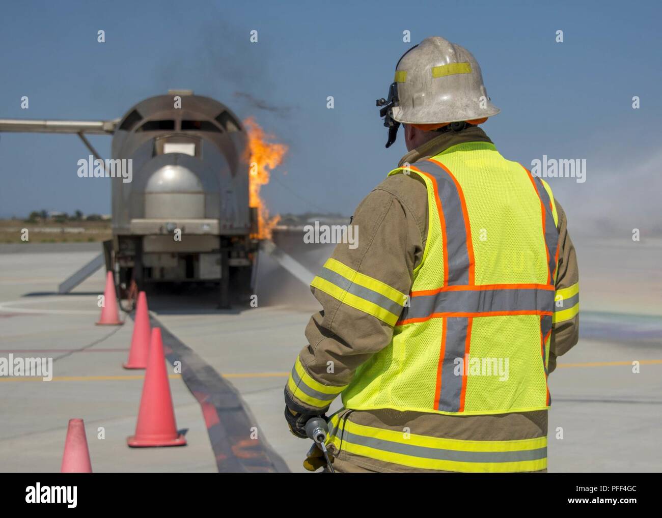 NAVAL SUPPORT ACTIVITY SOUDA BAY, Greece (June 13, 2018) Patrick Murphy, Assistant Fire Chief, Naval Support Activity (NSA) Souda Bay, Greece, ignites a fire on a Mobile Aircraft Fire Trainer Device (MAFTD) during a simulated emergency landing exercise, June 13, 2018, at NSA Souda Bay. NSA Souda Bay recently participated in various scenarios that simulated command-level and tactical decision-making as part of an Operational Readiness Assessment evaluated by a Regional Training Team. Stock Photo