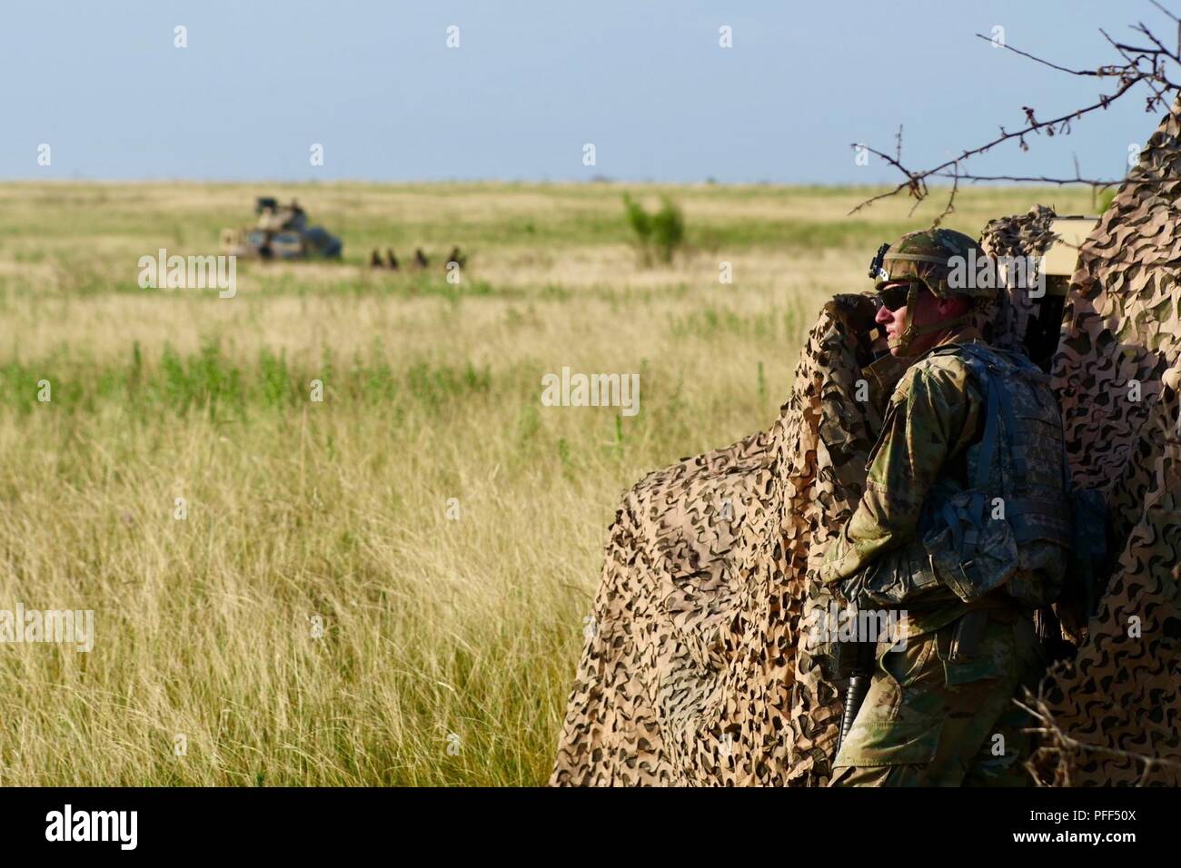 A Soldier with A Company 215th BSB, 3ABCT, 1CD directs a quick reaction force (not pictured) toward attacking opposition forces during the unit’s base defense exercise on Fort Hood, June 12. Stock Photo