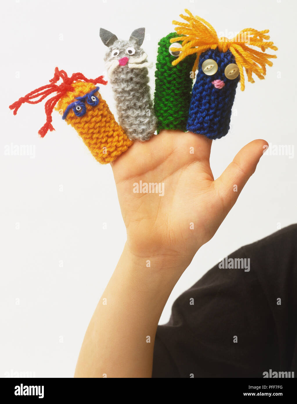 Four woolen finger puppets on a hand Stock Photo