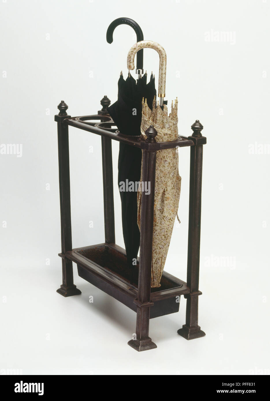 Ornate wooden stand holding two umbrellas upright, side view Stock Photo Alamy