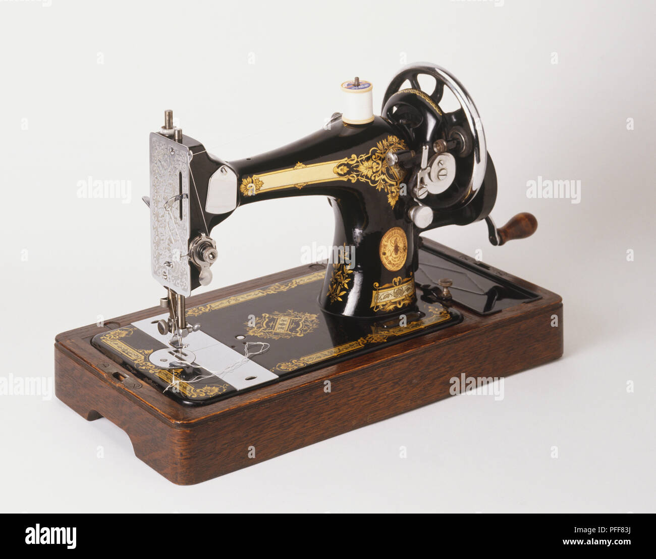 Old-fashioned sewing machine. Stock Photo